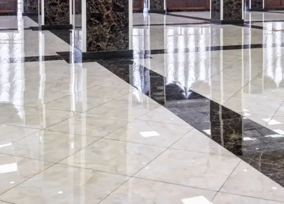 Marble floor in the luxury lobby of office or hotel. Real floor tile pattern with reflections for background. Shiny floor after professional cleaning.